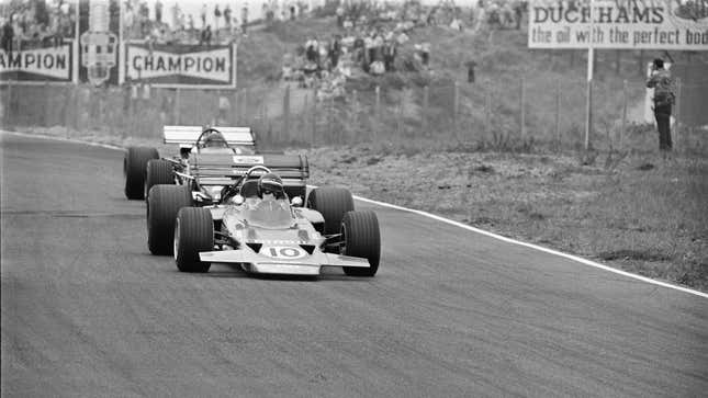 A black and white photo of 1970s Formula 1 cars. 