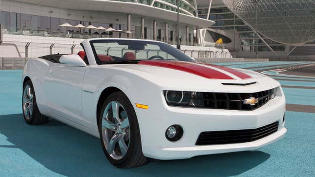 a white Camaro convertible with red stripes in the middle 