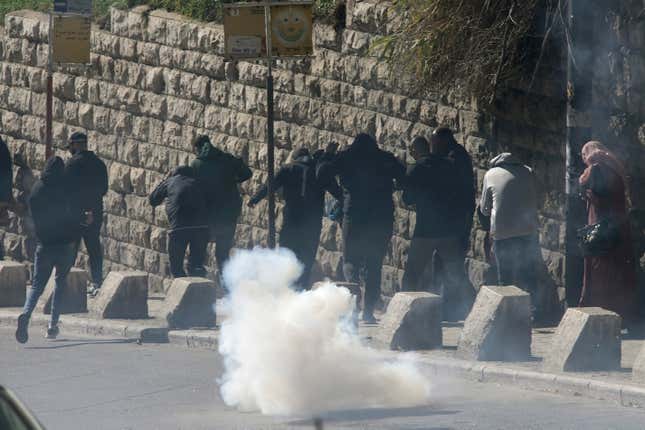 Israeli police uses tear gas to clear from the area Palestinian Muslim worshippers trying to enter the Old City for Friday prayers at the Al-Aqsa Mosque, in Jerusalem, Friday Dec. 22, 2023. (AP Photo/Mahmoud Illean)