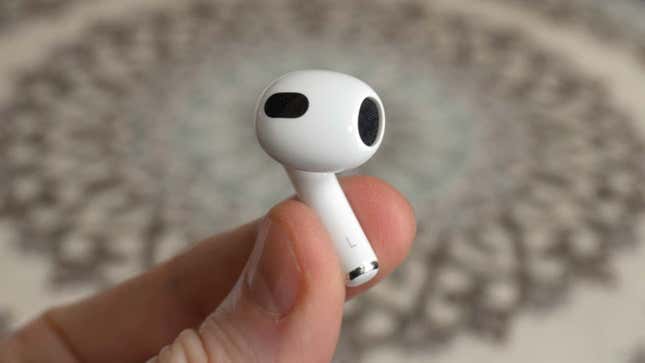 a photo of a person holding an airpod