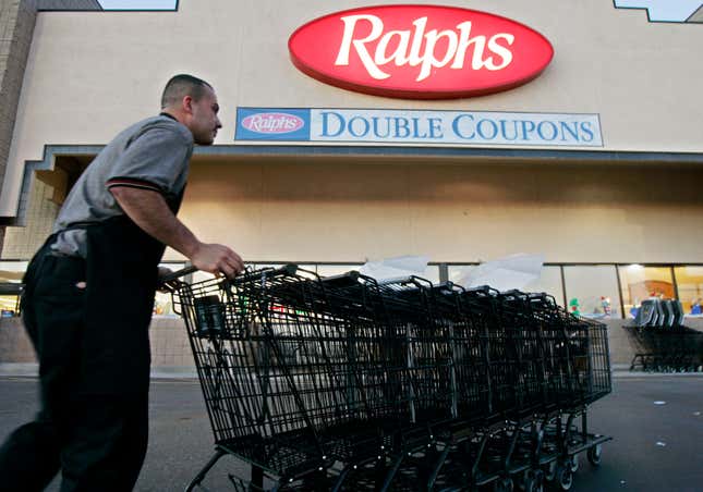 FILE -Francisco Luna collects shopping carts outside of a Ralphs grocery store in Los Angeles on Monday, Dec. 5, 2005. California sued the Ralphs supermarket chain on Thursday, Ded. 21, 2023, alleging that it violated state law by asking job-seekers whether they had criminal records and illegally rejecting hundreds of applicants (AP Photo/Kevork Djansezian, File)