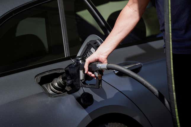 Commuter filling the tank at a gas station.