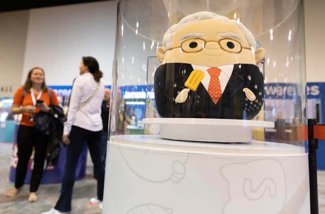 FILE - The Squishmallows booth sells toys modeled after Warren Buffett, pictured, and Charlie Munger in the exhibit hall for the Berkshire Hathaway annual meeting, Saturday, May 6, 2023, in Omaha, Neb. In a lawsuit filed Monday, Feb. 12, 2024, Kelly Toys and parent company Jazwares accused Build-A-Bear&#39;s new “Skoosherz” line of copying Squishmallows&#39; look and feel. Skoosherz toys have the “same distinctive trade dress” of Squishmallows, the complaint said — pointing to shape, face style, coloring and fabric similarities. (AP Photo/Rebecca S. Gratz, File)