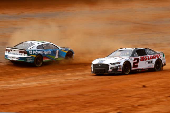 Ross Chastain, driver of the No. 1 Advent Health Chevrolet, spins after an on-track incident as Austin Cindric, driver of the No. 2 Discount Tire Ford, drives past during first practice for the NASCAR Cup Series Food City Dirt Race at Bristol Motor Speedway on April 15, 2022 in Bristol, Tennessee.