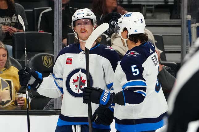 Nov 2, 2023; Las Vegas, Nevada, USA; Winnipeg Jets left wing Kyle Connor (81) celebrates with Winnipeg Jets defenseman Brenden Dillon (5) after scoring a goal against the Vegas Golden Knights during the second period at T-Mobile Arena.