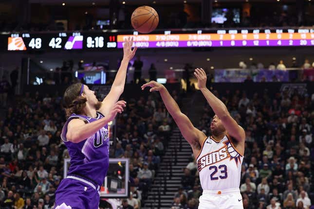 Nov 17, 2023; Salt Lake City, Utah, USA; Phoenix Suns guard Eric Gordon (23) shoots a three point shot over Utah Jazz forward Kelly Olynyk (41) in the second quarter at Delta Center.