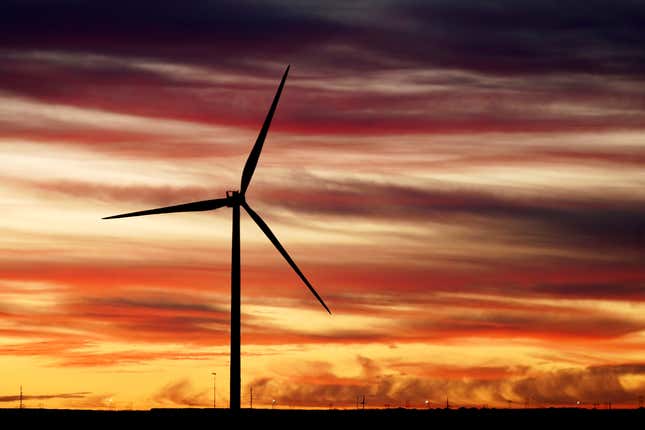 The sun rises behind a windmill before President Joe Biden&#39;s visit to CS Wind, the world&#39;s largest facility for wind tower manufacturing, Wednesday, Nov. 29, 2023, in Pueblo, Colo. (AP Photo/Jack Dempsey)