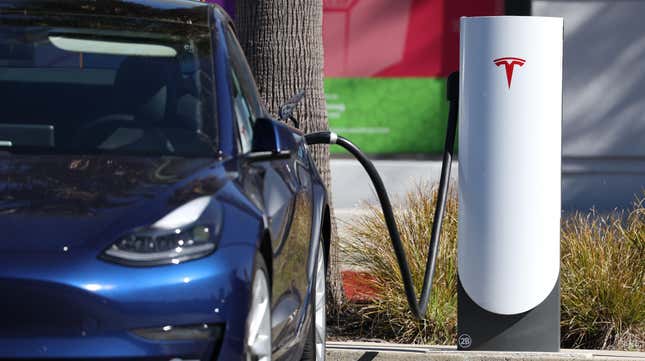 A Tesla car sits at a Tesla Supercharger station on February 15, 2023 in Sausalito, California.