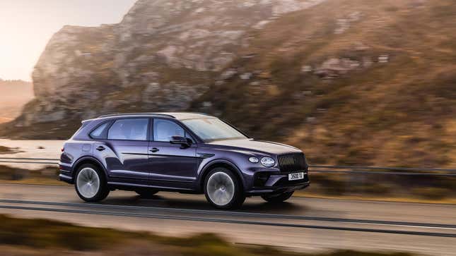 A photo of a purple Bentley Bentayga SUV extended wheelbase driving on a highway. 