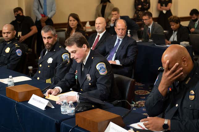 Aquilino Gonell, sergeant of the U.S. Capitol Police, Michael Fanone, officer for the Metropolitan Police Department, and Harry Dunn (far right), private first class of the U.S. Capitol Police, listen while Daniel Hodges, officer for the Metropolitan Police Department, testifies during a hearing of the House select committee investigating the January 6 attack on the U.S. Capitol on July 27, 2021.