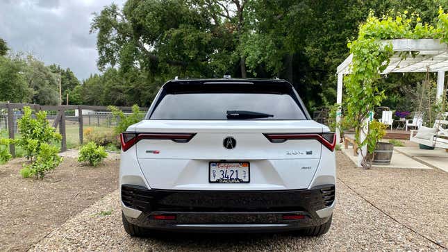 A straight up rear end shot of a white ZDX Type S in a garden