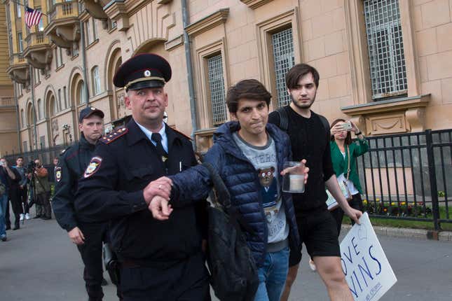 A Russian police officer detains a gay rights activist at the US Embassy in Moscow.