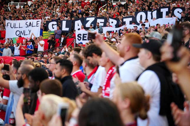 Manchester supporters await the start of the English Premier League soccer match between Manchester United and Brentford at the Old Trafford stadium in Manchester, England, Saturday, Oct. 7, 2023.(AP Photo/Jon Super)