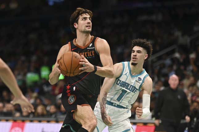 Nov 10, 2023; Washington, District of Columbia, USA;  Washington Wizards forward Deni Avdija (8) makes aa move to the basket y Charlotte Hornets guard LaMelo Ball (1) during the first half at Capital One Arena.