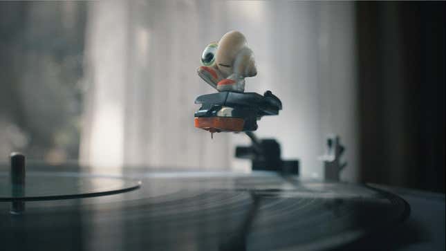 A still from Marcel the Shell With Shoes On showing Marcel on top of a vinyl record needle