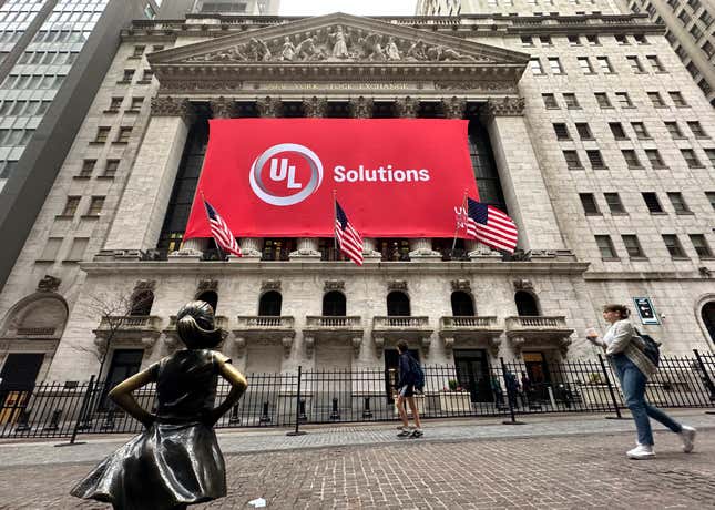 People pass the Fearless Girl statue outside of the New New York Stock Exchange on Friday, April 12, 2024 in New York. (AP Photo/Peter Morgan)