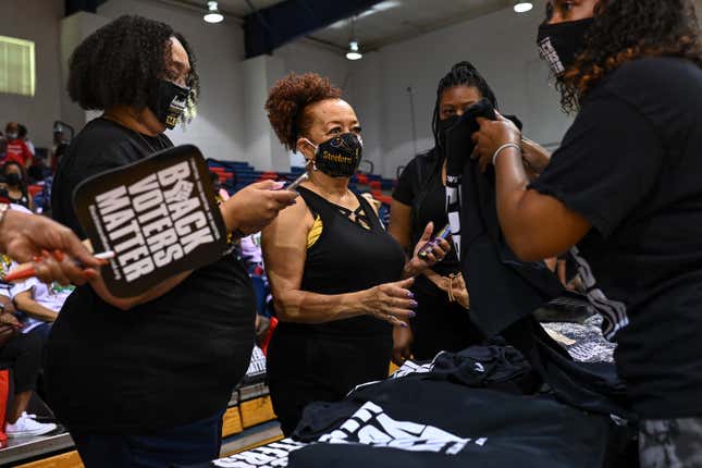 JACKSON, MS - June 19: People attend a Black Voters Matter event as they buy tee shirts at Tougaloo College on June19, 2021 in Jackson, Mississippi. LaTosha Brown and Cliff Albright, co-founders of Black Voters Matter and other members of the organization are taking part in a Freedom Ride during a bus tour through Black Belt states to Washington DC for voting rights as Republican political leaders in several states propose new voting laws to limit voter access. The U.S. Senate is scheduled to vote on a voting rights bill on Tuesday, June 22 at the U.S. Capitol in Washington DC.