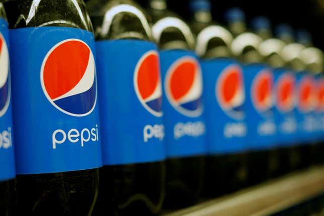 Row of Pepsi bottles on store shelf