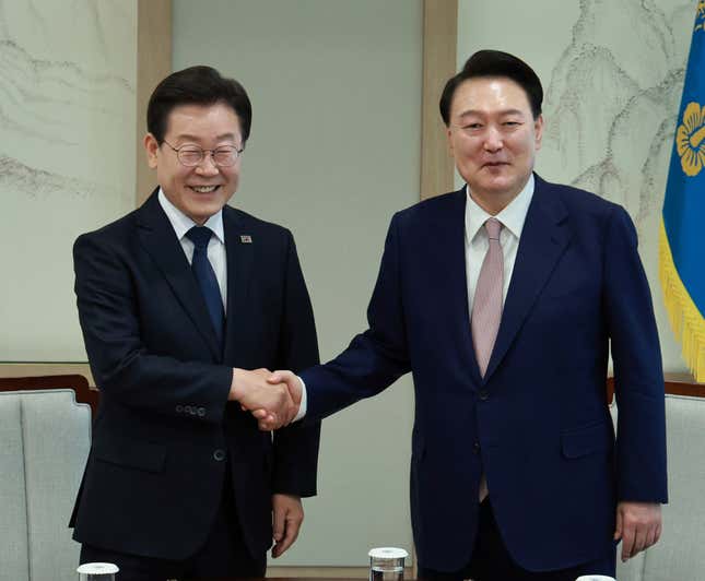 South Korean President Yoon Suk Yeol, right, shakes hands with main opposition Democratic Party leader Lee Jae-myung during a meeting at the presidential office in Seoul South Korea, Monday, April 29, 2024. (Hong Hae-in/Yonhap via AP)