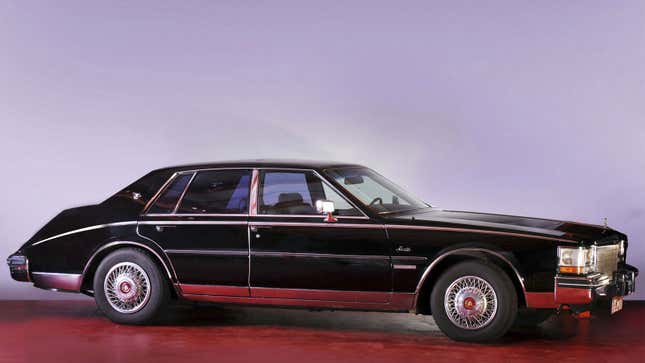 A photo of a black Cadillac Seville sedan. 