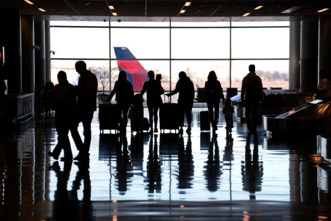 FILE - People pass through Salt Lake City International Airport Wednesday, Jan. 11, 2023, in Salt Lake City. To catch up with your credit-savvy friends, you may be considering a credit card that earns cash-back or travel rewards. If you have one already, perhaps you want to add a second card to the mix to earn even more. (AP Photo/Rick Bowmer, File)