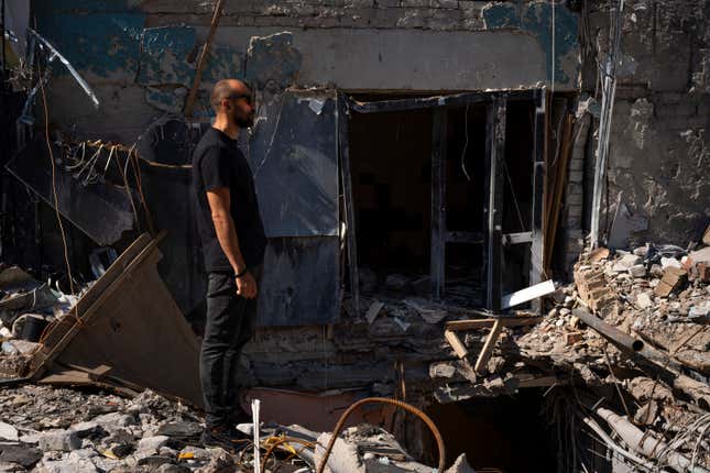 Dmytro Ihnatenko, owner of the destroyed Ria Pizza, stands beside a wide hole left from an Iskander missile that Russian forces used to strike a restaurant in June, killing 13 people and reducing the building to rubble, in Kramatorsk, Ukraine, Wednesday, Sept. 13, 2023. Russia&#39;s deadly attack on a beloved pizzeria in eastern Ukraine in June was painful for residents. The rubble remains in Kramatorsk as a reminder of the risk for businesses so close to the front lines. But many other shops and restaurants have defied the threat and reopened in recent months. (AP Photo/Hanna Arhirova)