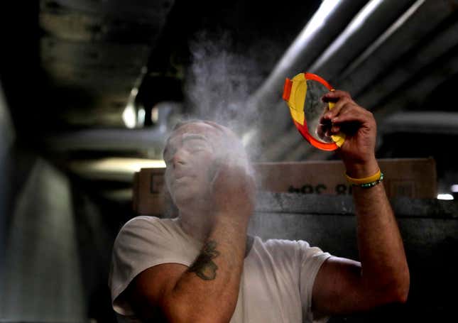 Boss clown Sandor Eke dusts his face with powder before performing in a show, May 5.