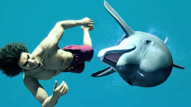 A man swimming under water looks at a dolphin. 