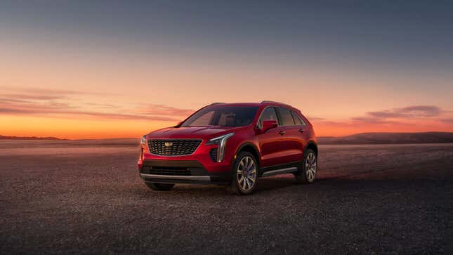 A photo of a red Cadillac XT4 SUV at sunset. 