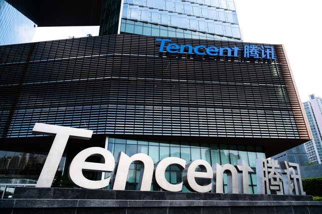 tencent sign in front of a building with a tencent logo displayed in the top right corner