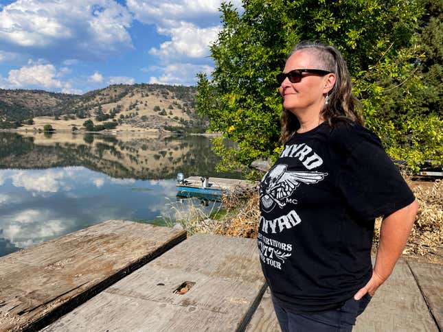 Sami Jo Difuntorum, Cultural Preservation Officer, Shasta Indian Nation, looks out on Sunday, Sept. 17, 2023, at a reservoir from Copco 1 damn, that will be drawn down next year as part of the largest dam removal project in United States history. The Shasta Indian Nation hopes to reclaim some of its land which was flooded when the dams were built a century ago. (AP Photo/Haven Daley)