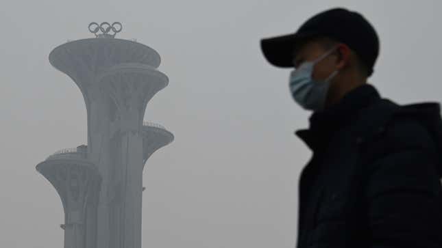 A man walks in the Olympic Park during a smoggy day in Beijing on January 24, 2022. 