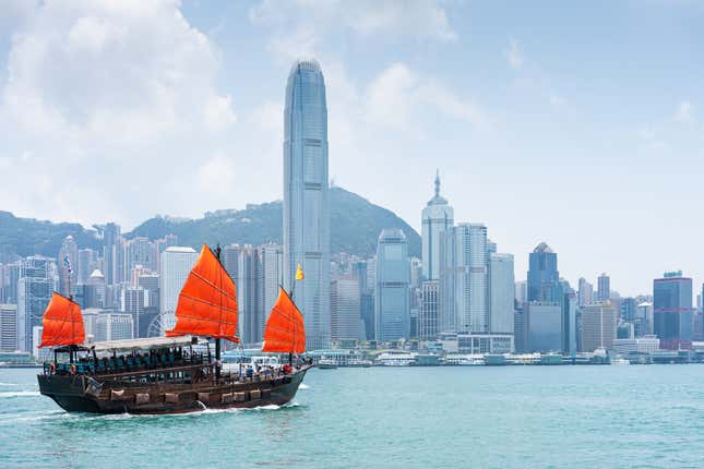 Victoria Harbour in Hongkong, China, mit einem antiken Segelboot und der Skyline