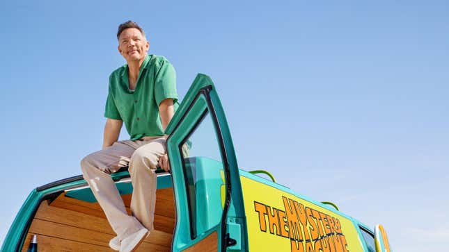 Actor Matthew Lillard, who played Shaggy in the 2002 Scooby-Doo live action film, sits on top of the Mystery Machine.