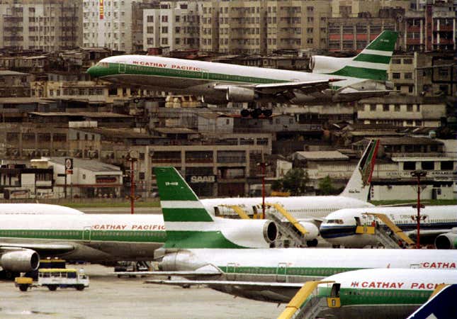 A Cathay Pacific Lockheed Tri-star jet lands at Hong Kong's Kai Tak international airport August 6 to join others gathered on the tarmac - RTXFAVT