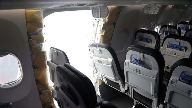 Several airplane seats and a hole where the emergency exit door was on a Boeing 737 Max 9.