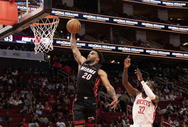 Oct 20, 2023; Houston, Texas, USA; Miami Heat forward Justin Champagnie (20) dunks as Houston Rockets forward Jeff Green (32) defends in the fourth quarter at Toyota Center.