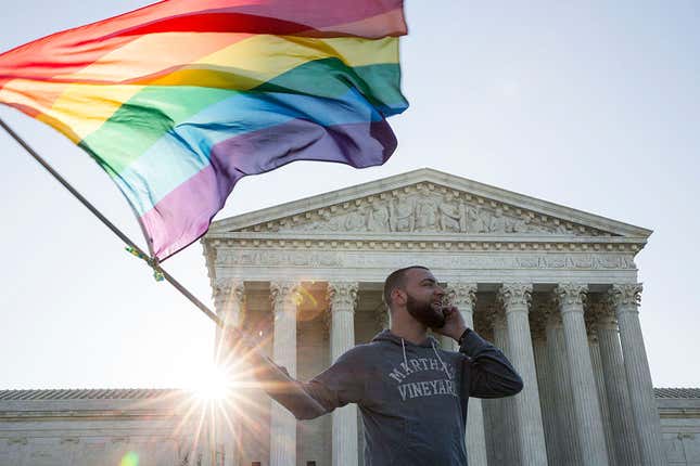 : Same-sex marriage supporter Vin Testa, of Washington, DC, waves a rainbow pride flag near the Supreme Court, April 28, 2015, in Washington, DC. On Tuesday, the Supreme Court will hear arguments concerning whether same-sex marriage is a constitutional right, with decisions expected in June.