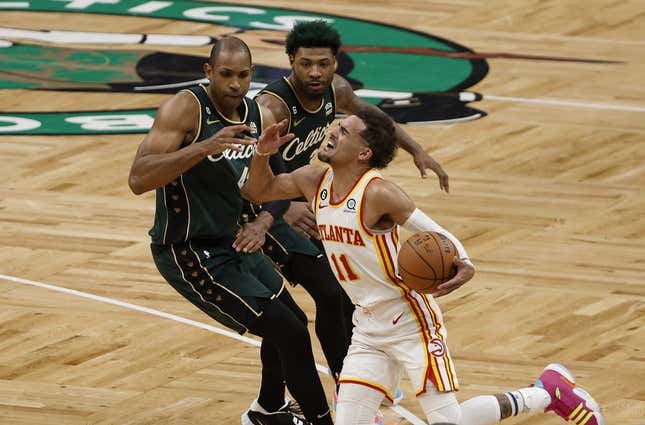 Apr 25, 2023; Boston, Massachusetts, USA; Atlanta Hawks guard Trae Young (11) gets fouled by Boston Celtics center Al Horford (42) during the fourth quarter of game five of the 2023 NBA playoffs at TD Garden.