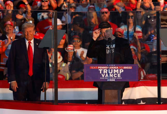 Tesla CEO Elon Musk (R) stands alongside Republican presidential nominee and Former President Donald Trump during a campaign rally on October 5, 2024, in Butler, Pennsylvania. 