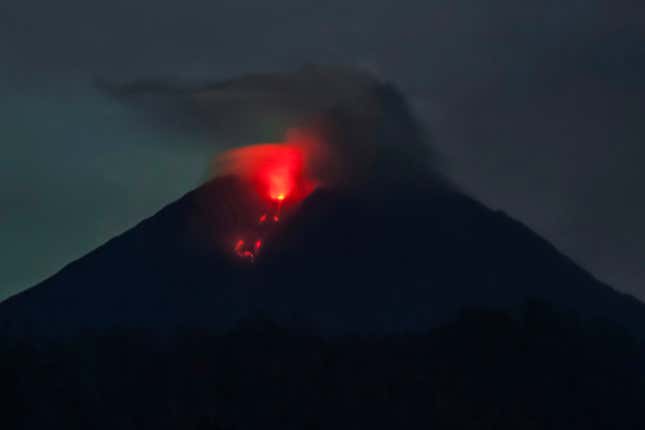 Mount Semeru spews lava as pictured from Sumber Wuluh village in Lumajang on December 6, 2021.