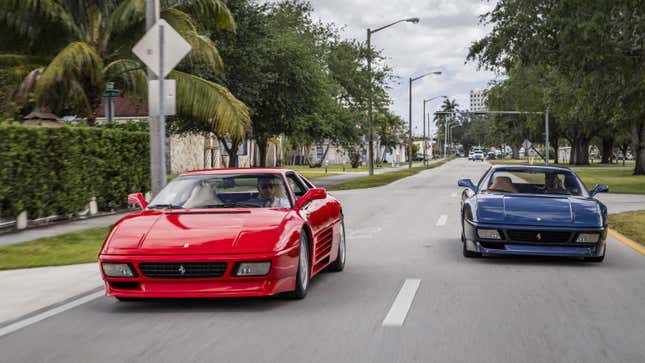 A photo of two Ferrari sports cars on a road. 