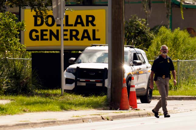 FILE - Law enforcement officials continue their investigation at a Dollar General Store that was the scene of a mass shooting, Aug. 27, 2023, in Jacksonville, Fla. Family members of three Black people who were fatally shot this summer inside the Dollar General store by a shooter who had posted racist writings sued the store&#39;s owner, operator and security contractor on Monday, Dec. 4, for negligence, claiming lax security led to their loved ones&#39; deaths. (AP Photo/John Raoux, File)