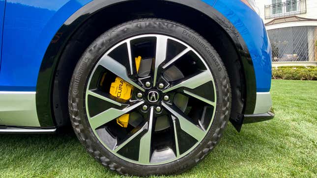 A close-up of the wheel of a blue ZDX Type S