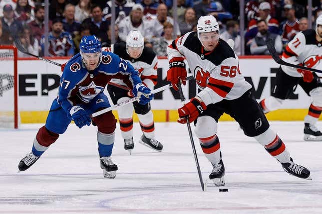 Nov 7, 2023; Denver, Colorado, USA; New Jersey Devils left wing Erik Haula (56) controls the puck ahead of Colorado Avalanche left wing Jonathan Drouin (27) in the first period at Ball Arena.