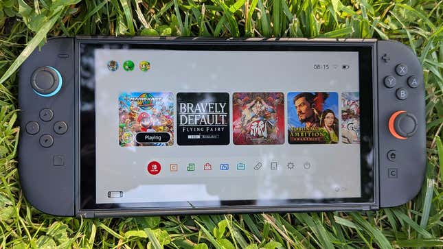 A Switch 2 sits on the grass.