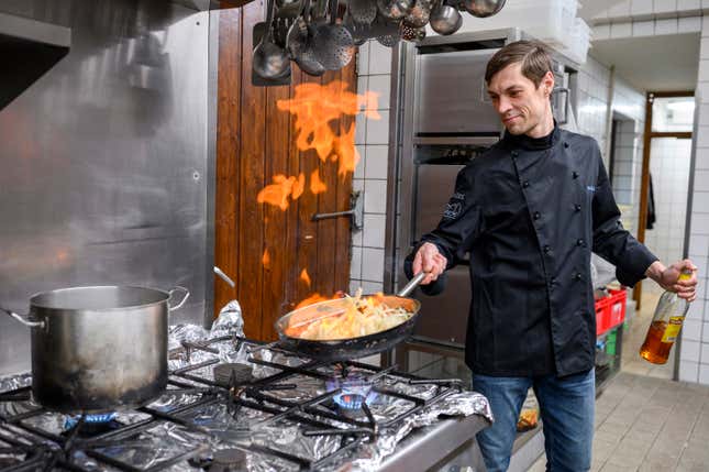 FILE - Vitaly from Kiev helps in the kitchen with the Glas family in Dippertz, Germany, Tuesday, April 5, 2022. He arrived in Germany on March 17, together with his family, after fleeing from Kiev. A report says Poland is losing large numbers of Ukrainian refugees from its workforce as they travel to Germany to seek higher wages and government benefits in the rich Western economy. Although the refugees are not economic migrants, they are increasingly taking on work as the war in Ukraine drags on for more than a year and a half. (Daniel Vogl/dpa via AP, File)