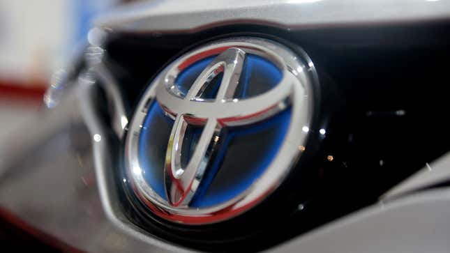 A photo of a Toyota logo on a car. 