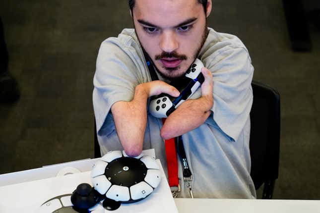 Martin Shane uses a Sony Access controller, left, to play a video game at Sony Interactive Entertainment headquarters Thursday, Sept. 28, 2023, in San Mateo, Calif. (AP Photo/Godofredo A. Vásquez)