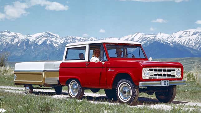 A photo of a red Ford Bronco SUV on a mountain path. 